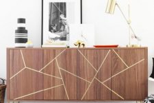 24 a Stockholm sideboard with gold hairpin legs and a geometric design made with gold foil tape
