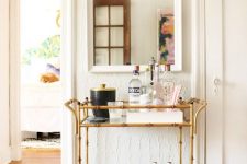 28 an elegant gold bamboo bar cart is a stylish addition and a must for a millennial living room