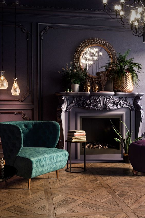 a beautiful vintage living room with a purple accent wall with molding, a fireplace, potted plants and blooms, a chandelier and a green chair