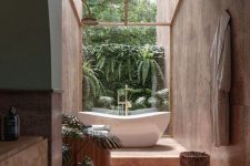 a biophilic bathroom clad with terracotta tiles, with a wooden vanity and a tree stump and a living wall is a gorgeous space