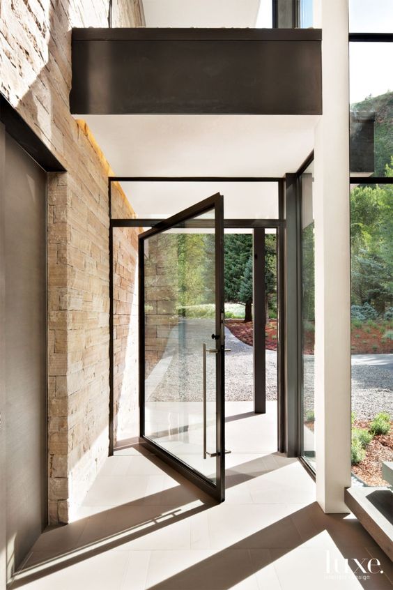 a black framed pivot front door gives a very stylish and ultra-modern feel to the space and makes it wow, bold and cool