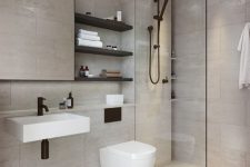 a clean contemporary bathroom clad with neutral tiles, a shower space, a mirror, black shelves and black fixtures