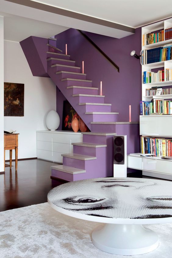 a lilac accent wall paired with a matching staircase gives a lovely touch of color and a unique decor feature to the space