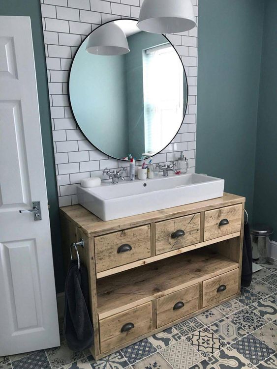 a reclaimed wood bathroom vanity with drawers is a cool idea for a millennial bathroom and it will add a warming touch to the space