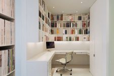 a very simple contemporary home office nook with lots of shelves for storage, a corner desk, a white chair and built-in lights