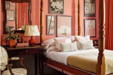 a vintage bedroom with an orange accent wall, a vintage wooden canopy bed, a gallery wall and dark stained furniture is all chic and cool