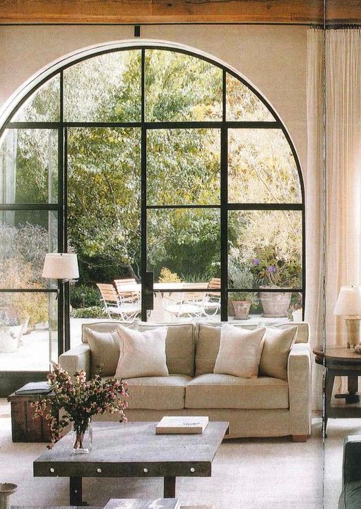 an arched doorway with glass French doors leading to the garden is an amazing idea for a modern farmhouse space