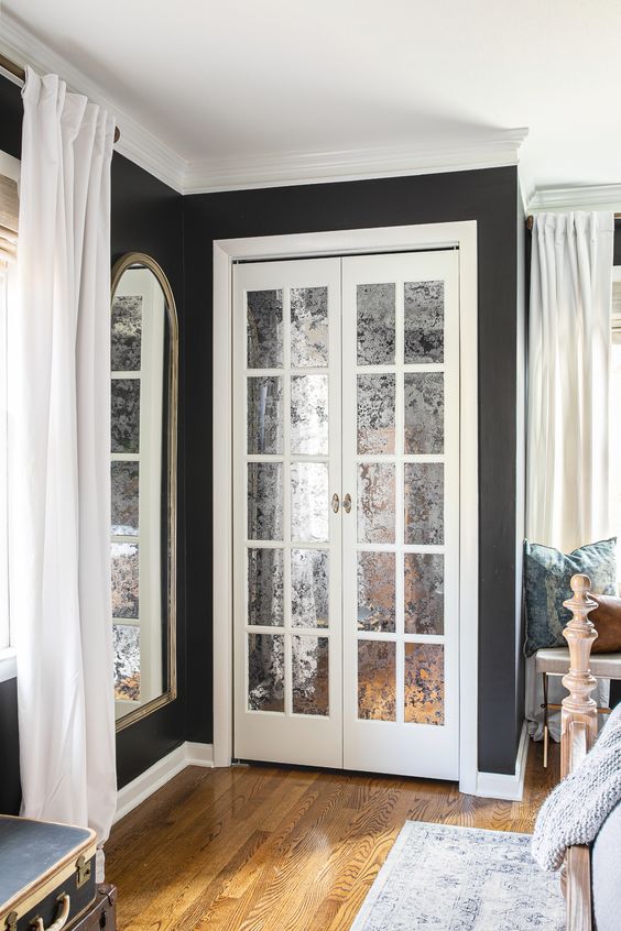 mirrored French doors leading to a closet are gorgeous for a refined and elegant space and that mirror touch is lovely