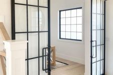 sliding black French doors with handles are perfect for rustic or farmhouse spaces and won’t take any space at all