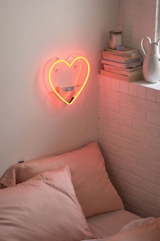 a pretty and cute yellow neon light on the wall is a gorgeous idea for a Gen z bedroom, it will bring a bit of cuteness here