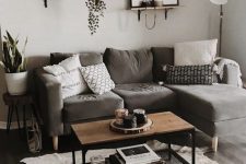 22 a light grey living room with a taupe sectional, a mini gallery wall, potted plants, an animal skin rug and a small coffee table