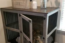 a farmhouse kennel with a dark countertop doubles as a console table and matches a farmhouse space