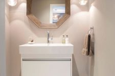 a modern powder room with a floating vanity