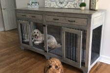 a whitewashed farmhouse dog kennel with doors and with drawers doubles as a console table in the room