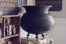32 beautiful and geeky Halloween decor with an elegant cauldron, a sign, some apothecary tubes and a blackbird for Harry Potter fans