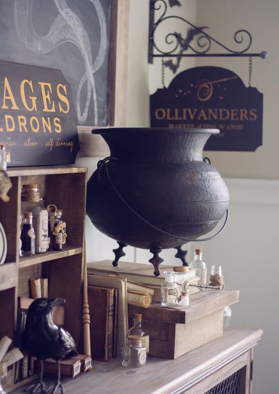 beautiful and geeky Halloween decor with an elegant cauldron, a sign, some apothecary tubes and a blackbird for Harry Potter fans
