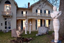 a Halloween yard with a number of mummies, tombstones, planters and spiders is perfect for Halloween