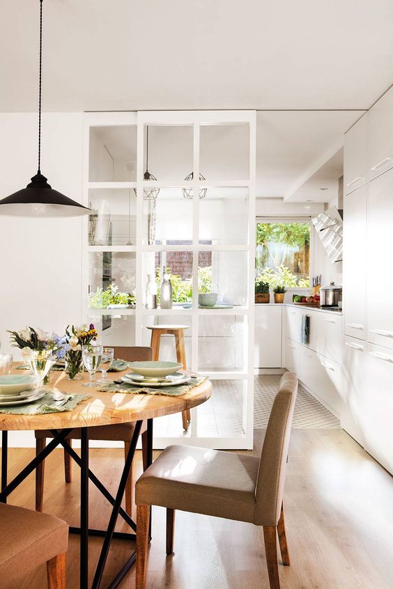 a beautiful French glass pocket door is perfect for separating a kitchen and a dining room and still make them not so divided