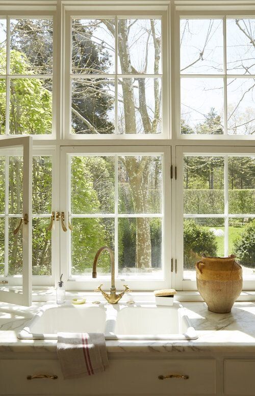 a big white French window is an ideal fit for a Provence styled kitchen done in neutrals, it brings a lot of natural light and cool views