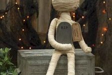 a cute and scary mini mummy decoration with a tombstone is a perfect idea for Halloween
