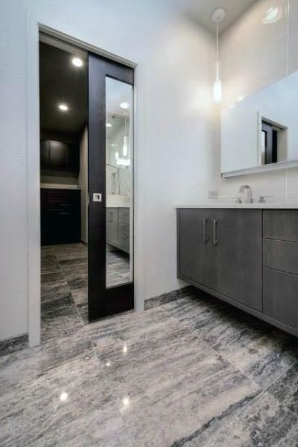 a dark-stained and mirror pocket door to the bathroom is a cool alternative to a usual door and a mirror at the same time