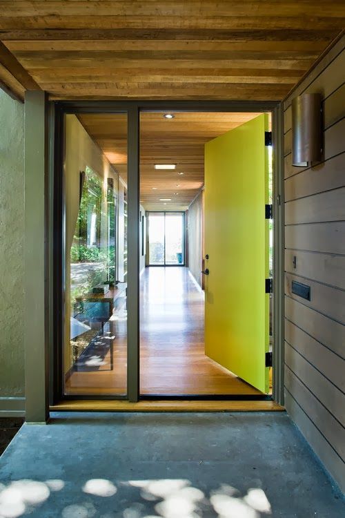 a neon yellow metal front door plus a window is a cool idea for a modern or contemporary home, and its color is amazing