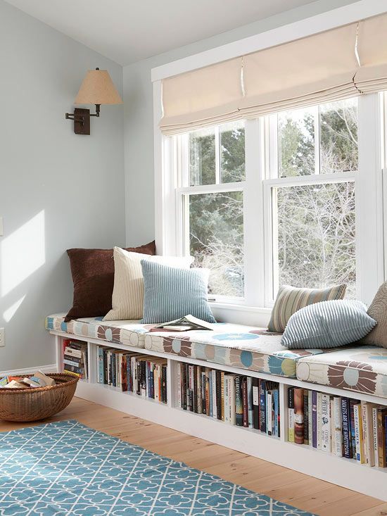 a windowsill bench with a cushion on top and a bookshelf inside it is perfect for a reading nook