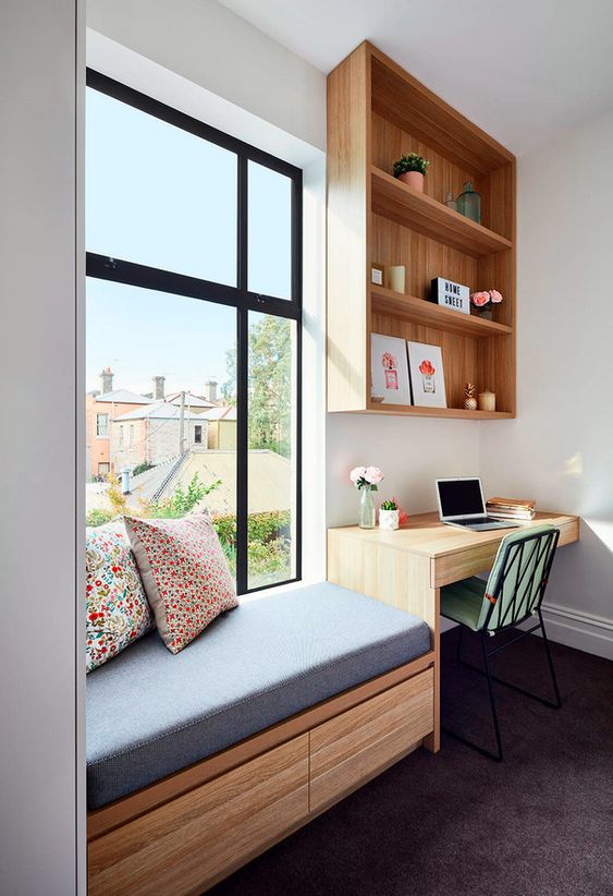 a windowsill daybed with an upholstered bench and colorful pillows plus a study space next to it look contemporary and fresh