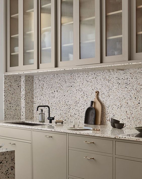 a neutral kitchen design with terrazzo elements