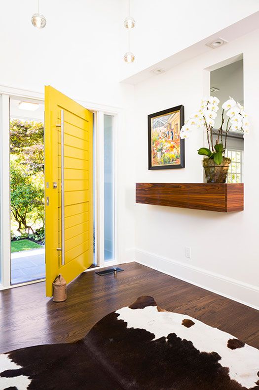 an oversized yellow planked square front door with oversized handles is a gorgeous idea for a modern or mid-century modern house
