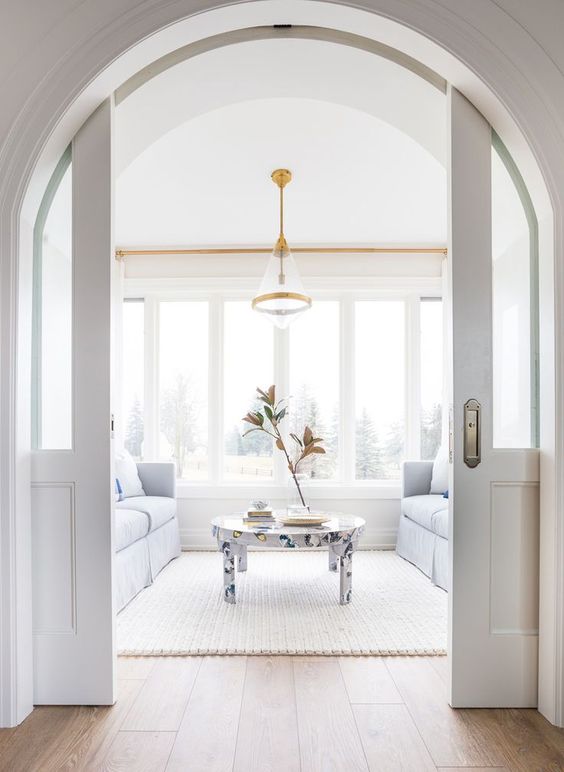 glass pocket doors for an arched doorway is a stylish idea to separate the spaces and make it with interest