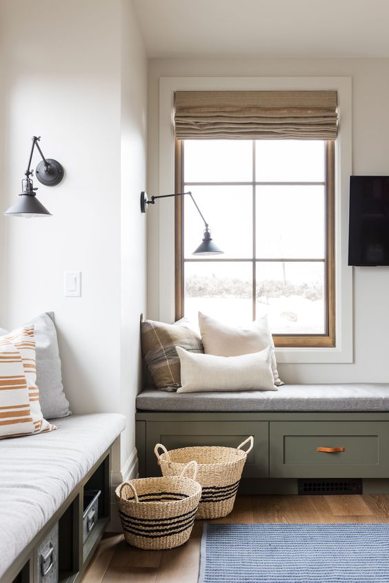 windows with built-in storage daybeds, with pillows and black sconces are amazing for reading and just enjoying the views