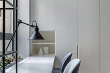 16 a clean minimalist home office with light grey storage units and a built-in shared desk, grey chairs and a table lamp is welcoming