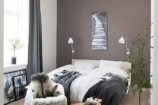 22 a beautiful boho bedroom with a taupe accent wall, a creamy upholstered bed and lovely bedding, a round table and a chair, a potted plant