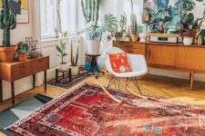 35 a bright mid-century modern living room with bold mismatching rugs, statement potted cacti and succulents and bright artworks