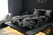 a bedroom with a dramatic black wall