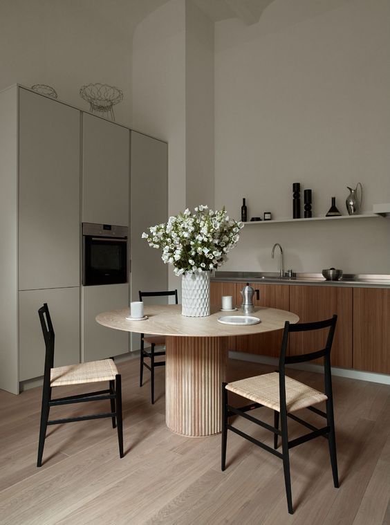 a refined minimalist kitchen with a dining space, with light-stained wood with various tones is a very chic and cool idea