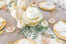 03 a beautiful glam Thanksgiving table setting with a striped runner and speckled plates, gold cutlery and glam embellished pumpkins plus greenery