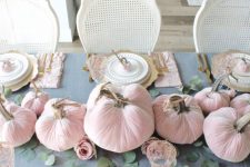 04 a chic and beautiful Thanksgiving tablescape with a grye tablecloth, pink velvet pumpkins and napkins, gold chargers and cutlery plus greenery