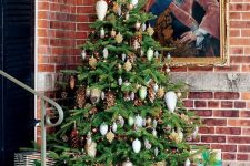 04 a forest Christmas tree with gold, white and silver pinecone ornaments, real pinecones, lights and vines is amazing