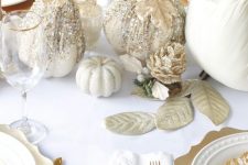 08 a glitz and glam neutral Thanksgiving tablescape with white linens, gold chargers and cutlery, white pumpkins decorated with glitter and gold leaves