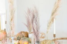 13 a modern glam Thanksgiving tablescape with pink plates, napkins, glasses, natural and pink grass, heirloom pumpkins and gold cutlery