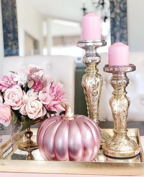 glam Thanksgiving decor with a pink metallic pumpkin, pink candles in shiny candleholders and pink blooms is amazing
