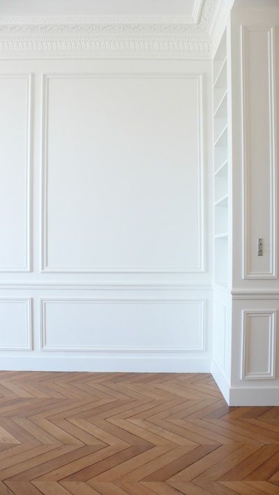 a beautiful parquet floor and layered ornated crown molding on the ceiling plus molding on the walls make the space very exquisite