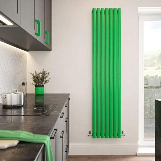 a contemporary kitchen with black and grephite grey cabinetry, a neon green radiator on the wall and matching accessories