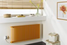 a contmeporary space with a narrow windowwill for displaying, baskets for storage and a small yellow radiator is cool