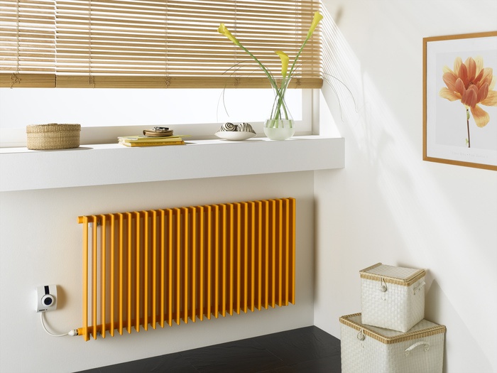a contmeporary space with a narrow windowwill for displaying, baskets for storage and a small yellow radiator is cool