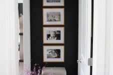 a cool one row grid gallery wall with stained wooden frames and black and white family pics – the shape gives the gallery wlal a modern look