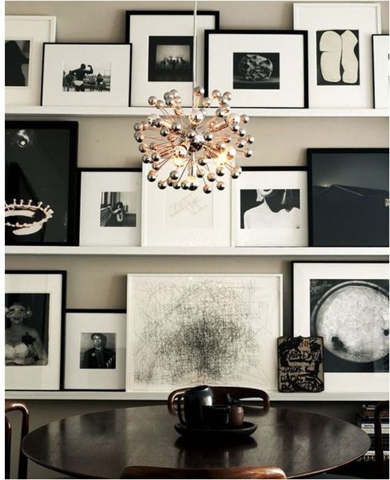 a lovely black and white ledge gallery wall with mismatching frames and matting is a very bold idea to take up a whole wall