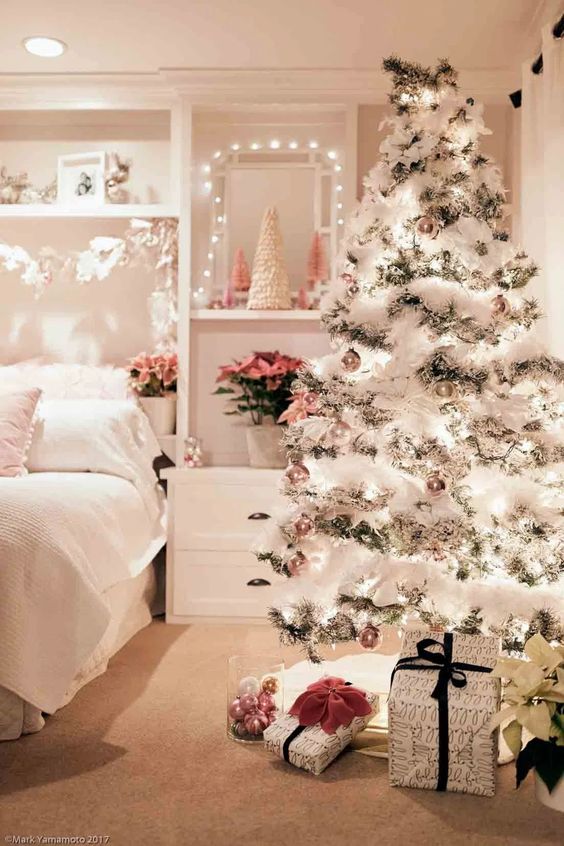 a lovely wonderland Christmas tree with lights, silver and blush ornaments, a white fluffy farland is amazing